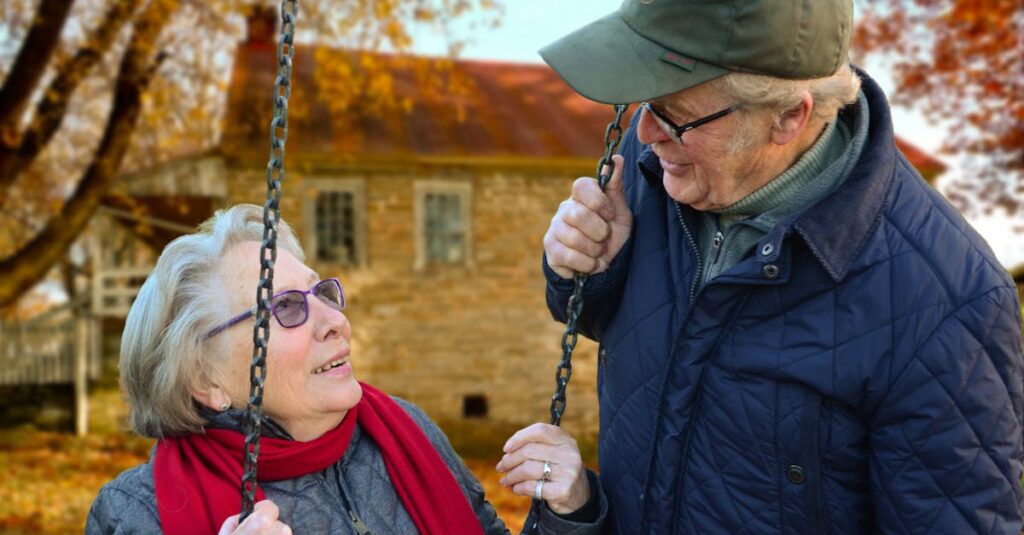 Man Standing Beside Woman on Swing