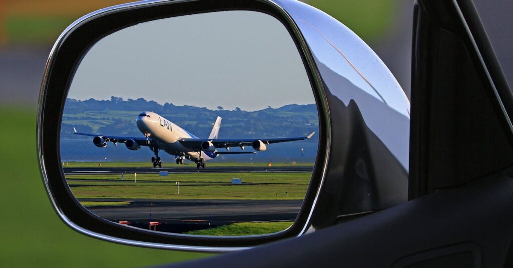 White Airplane Reflection on Car Side Mirror