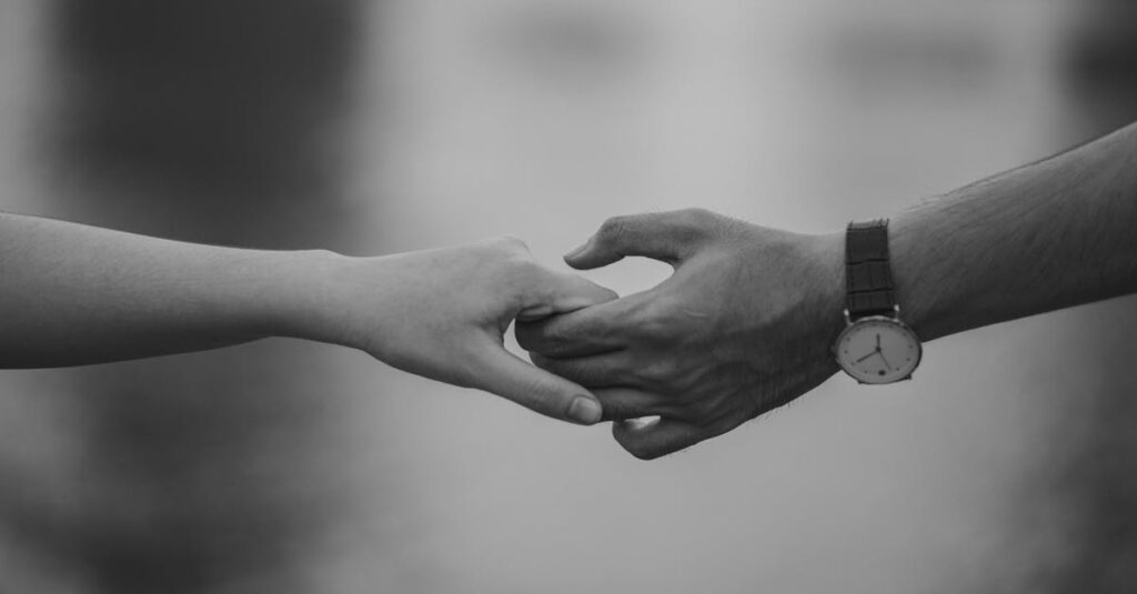 Monochrome Photo of Couple Holding Hands