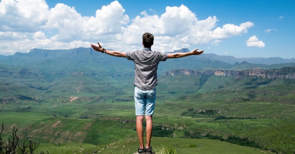 Man Wearing Grey Shirt Standing on Elevated Surface