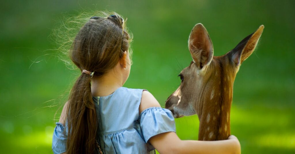 Girl Wearing Blue Top With her hand around a deer