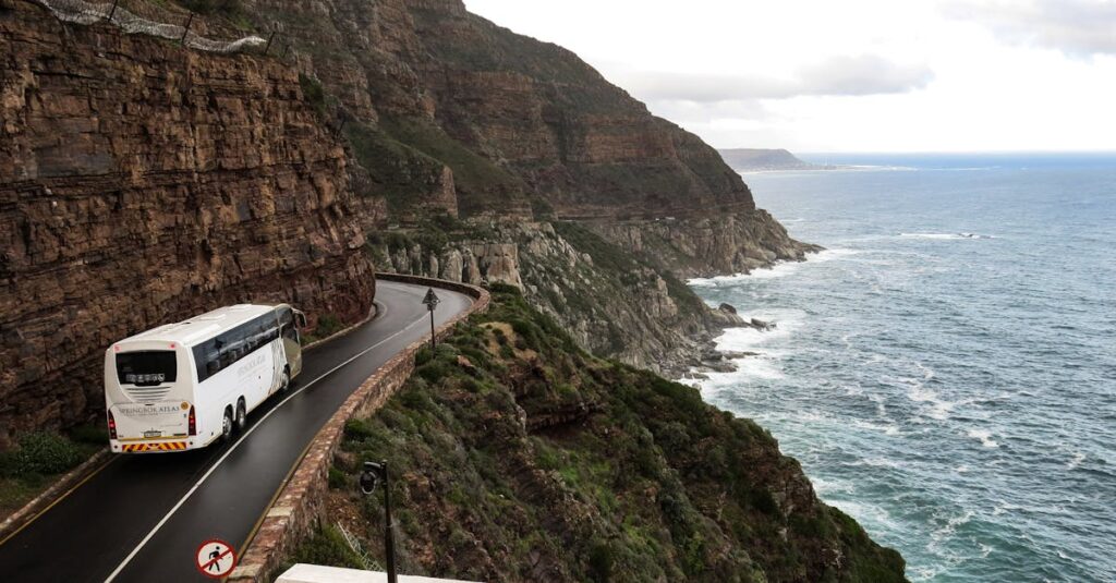 White Bus on Road Near Cliff