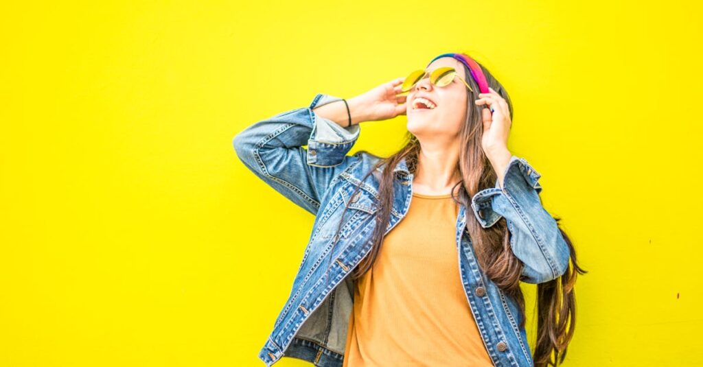 Smiling Woman Looking Upright Standing Against Yellow Wall