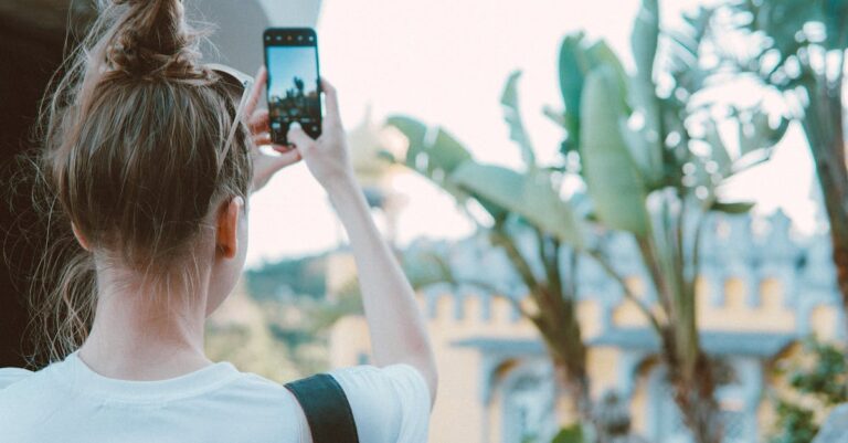 Photo of a Woman Taking Picture of Banana Trees