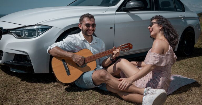 Woman in Dress Sitting with Man Playing Guitar by BMW Car