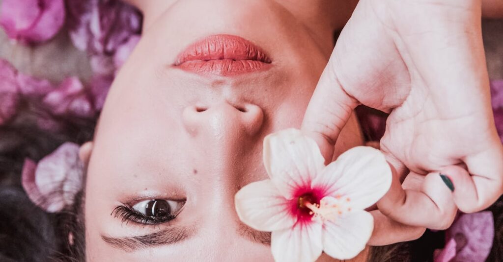 Photo of Woman Holding Pink Flower