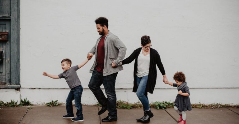 Family Of Four Walking At The Street