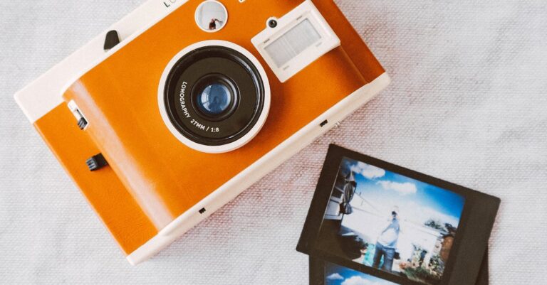 Orange and White Instant Camera on White Cloth