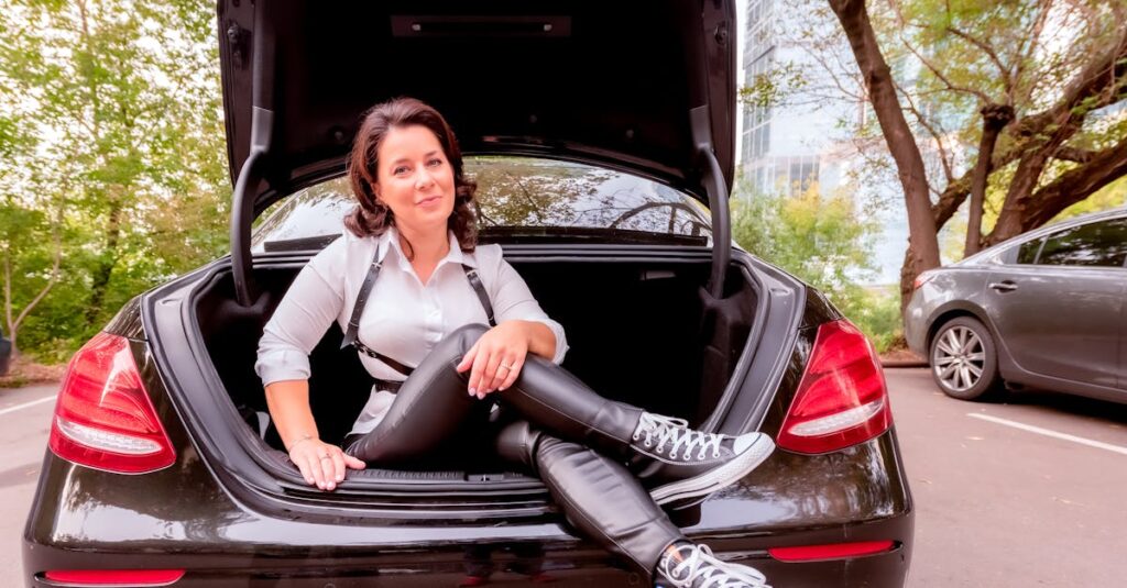 A woman sitting in the trunk of a car