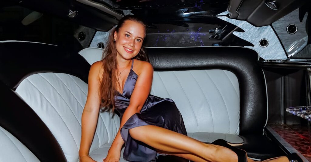 A woman sitting in the back of a limousine