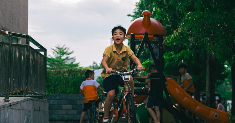 Boy Riding Bike in Urban Playground Setting