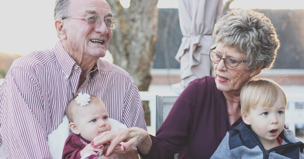 Grandmother and Grandfather Holding Child on Their Lap