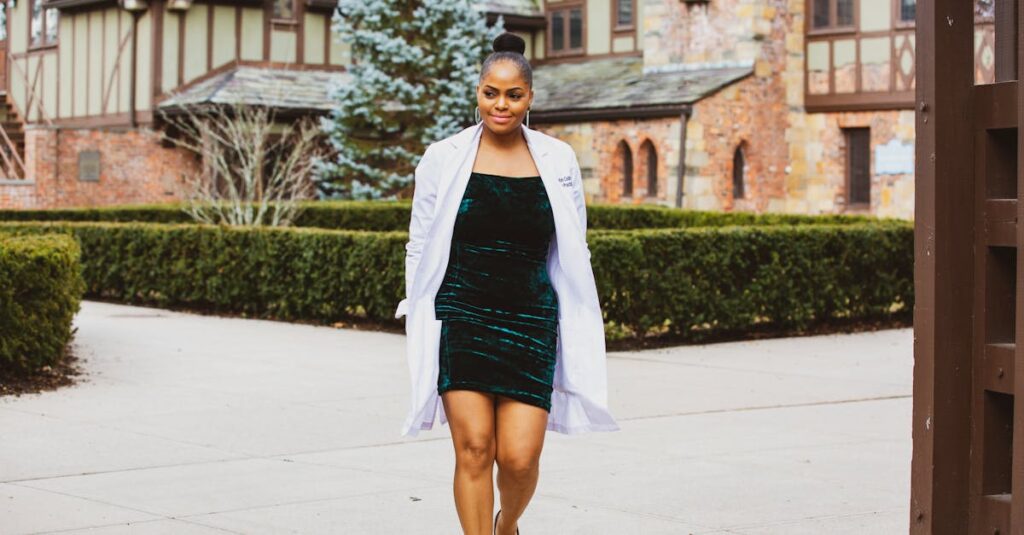 Woman in Green Dress and White Coat Walking on Gray Concrete Floor