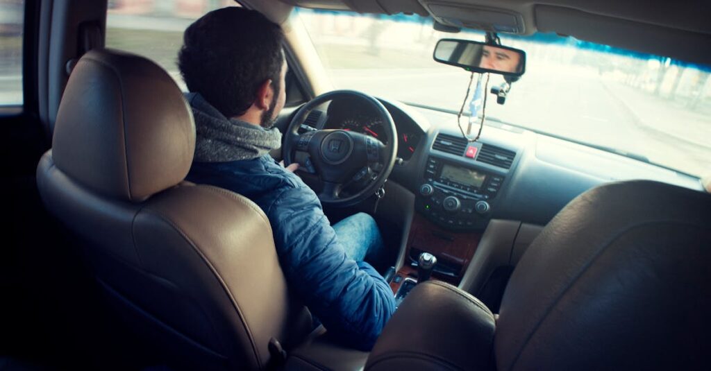 Man Wearing Blue Jacket Sitting Inside Car While Driving