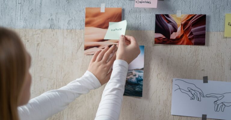 A Woman Putting a Sticky Note on a Moodboard