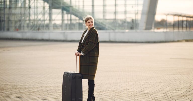 Cheerful female tourist with suitcase