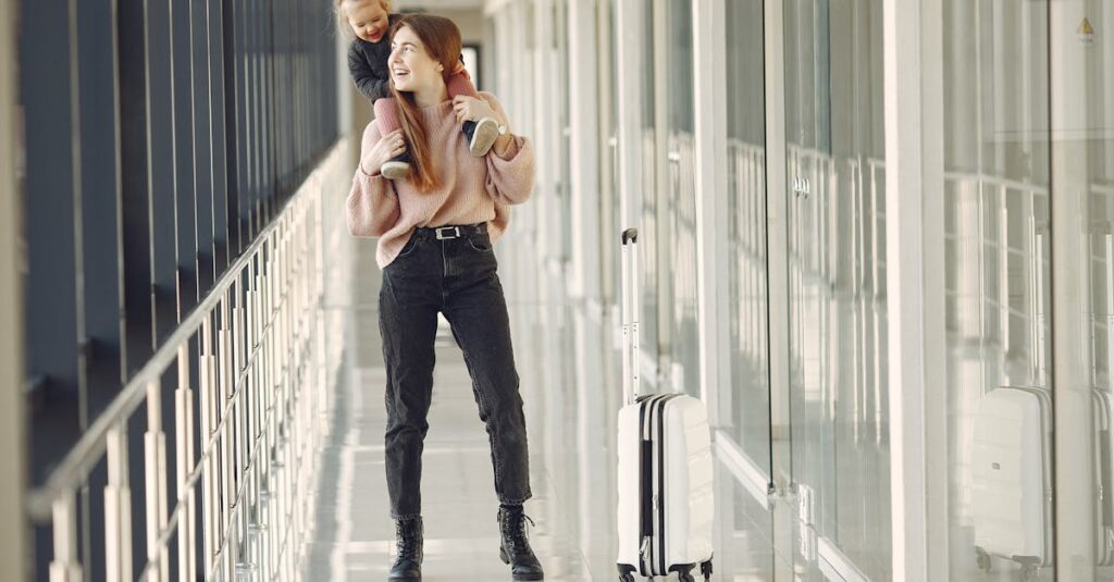 Cheerful woman with daughter and suitcase in airport