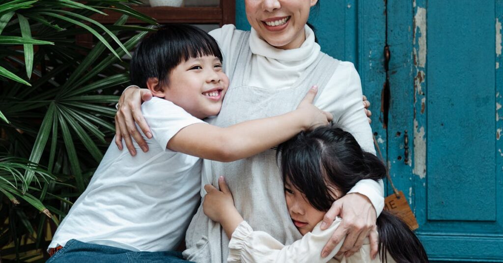 Photo of Woman Hugging Her Children While Smiling