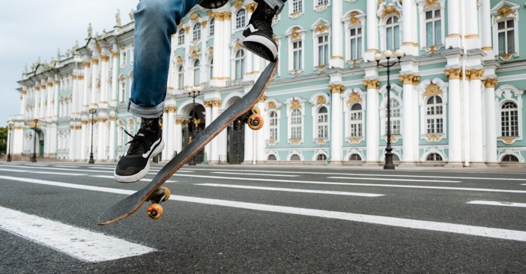 Man in Blue Denim Jeans and Black Sneakers Jumping on Black Metal Pole