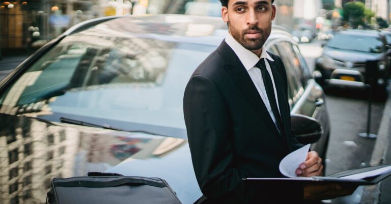 Man in Black Suit Leaning on His Car