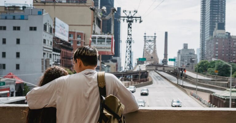 Unrecognizable couple hugging and enjoying New York City views