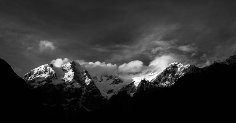 Grayscale Photo of Snow Covered Mountain