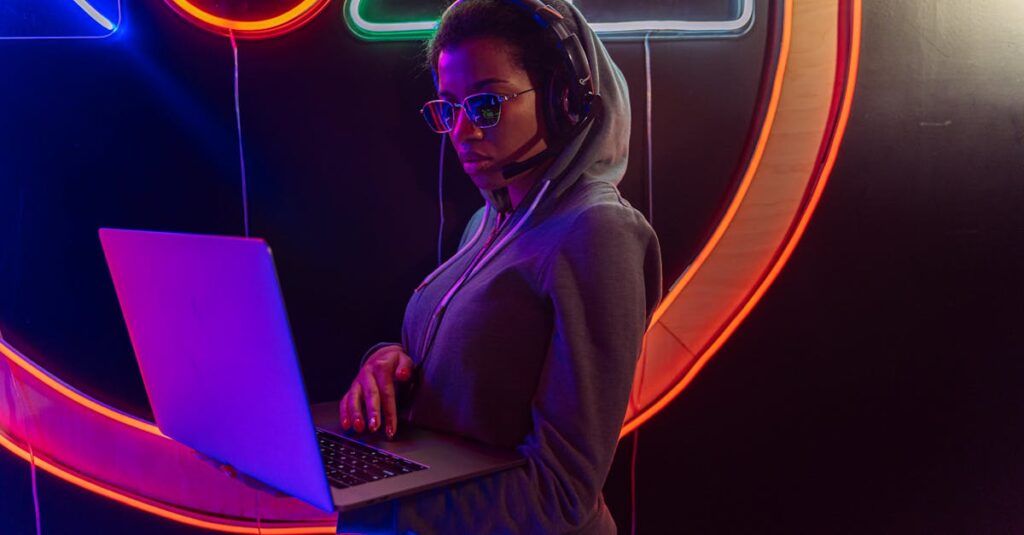 Woman in Purple Hoodie Using Macbook Pro