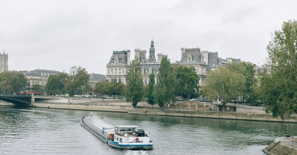 White and Blue Boat on Water Near City Buildings