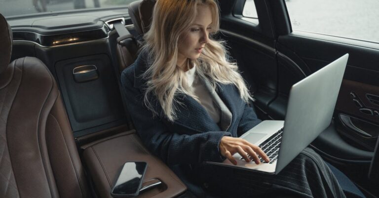 Woman in Blue Coat Sitting on Car Seat