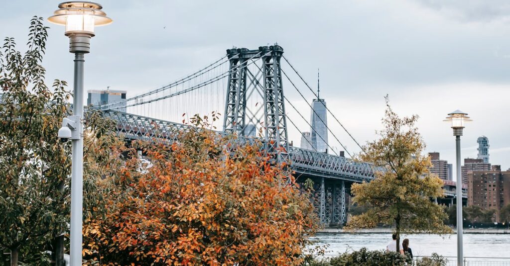 Scenery of urban New York City district with famous Manhattan Bridge in early autumn under cloudy sky