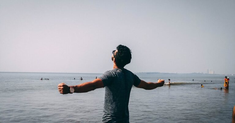 Photo of Man Wearing Gray Shirt Near Sea