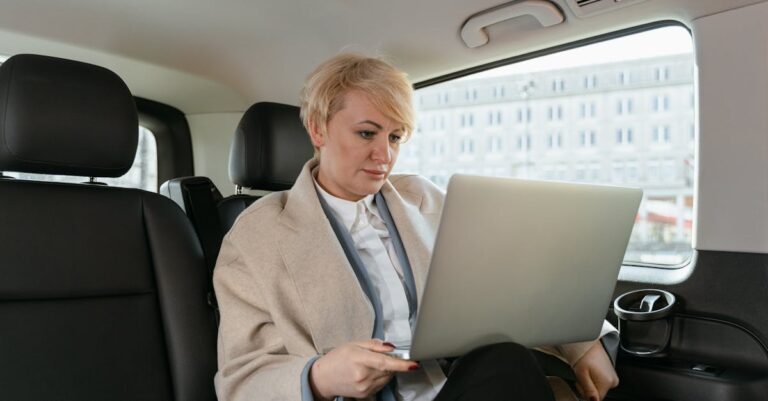 Woman Working while Sitting inside of a Car