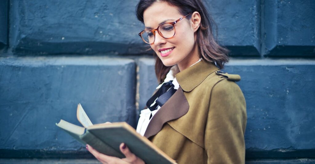 Woman In Brown Suede Peacoat Reading A Book