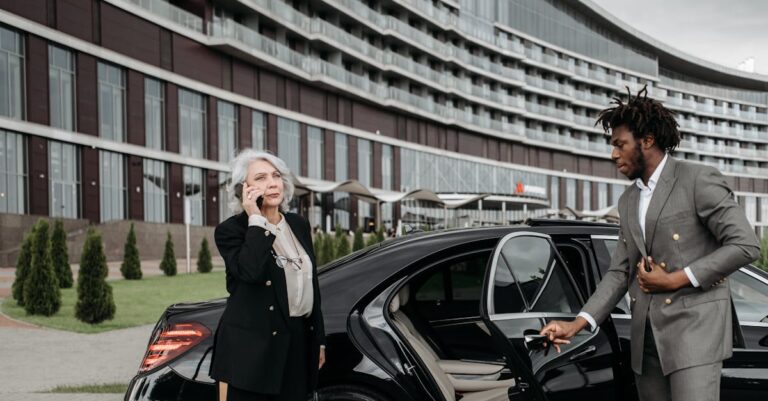 Man in a Gray Suit Opening a Car Door for a Woman in Black Suit