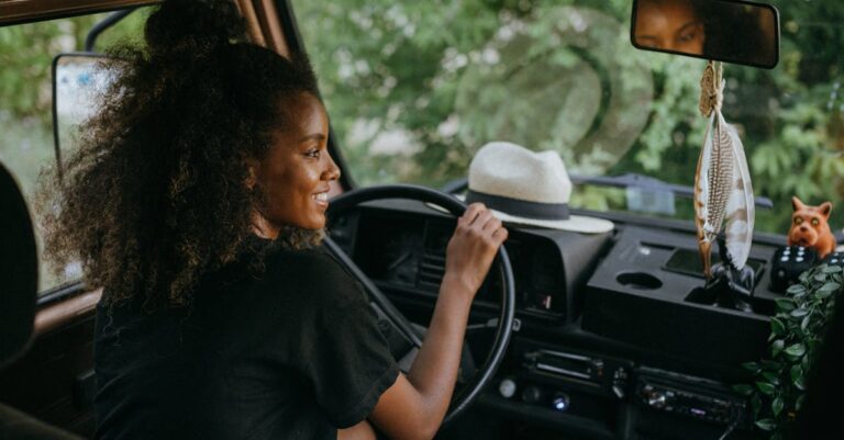 Woman in Black Shirt Driving Car