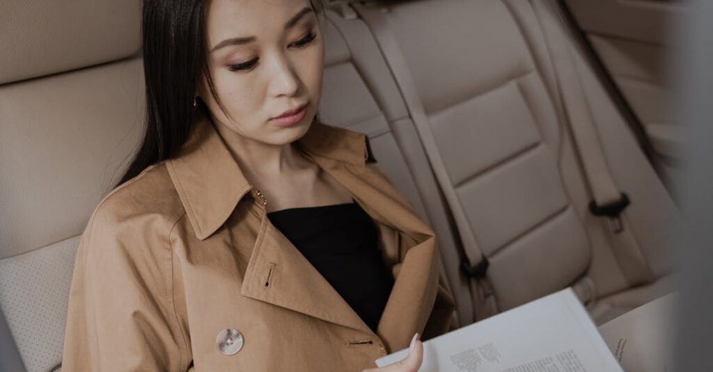 Woman in Brown Coat Reading Book