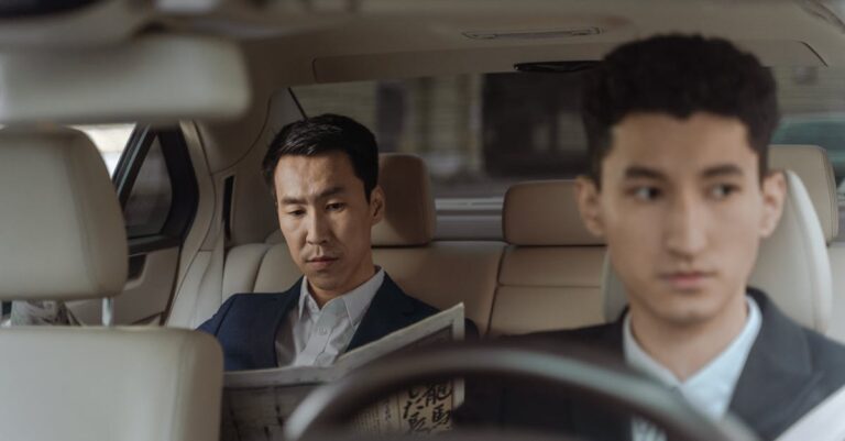 2 Men in White Suit Sitting Inside Car