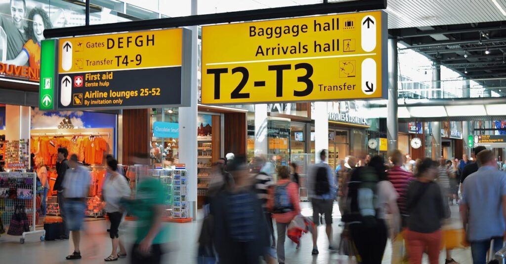 People Walking Beside Baggage Hall and Arrivals Hall Signage