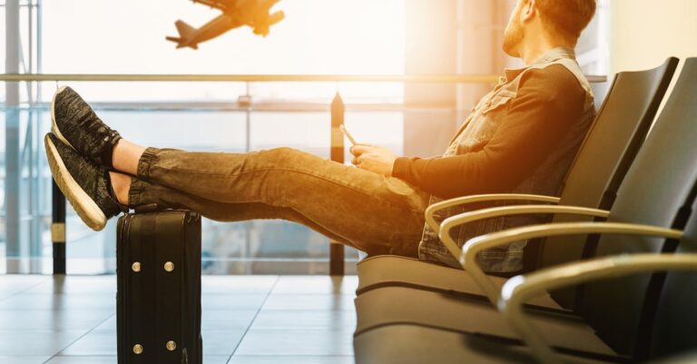 Man in airport waiting for boarding on plane