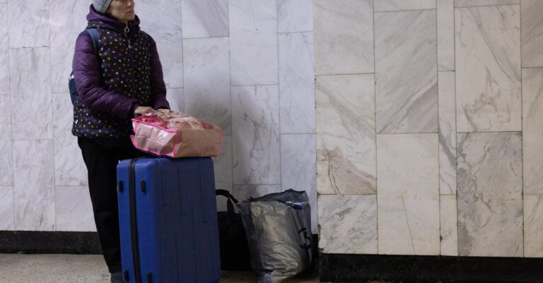 Woman Standing with Luggage