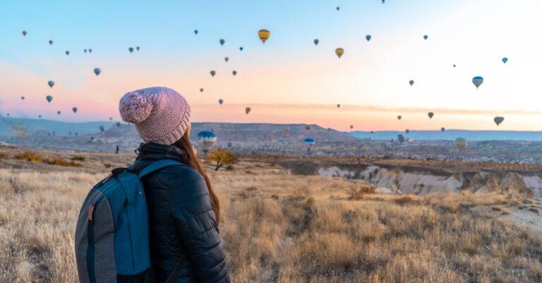 Woman Looking At Hot Air Balloons