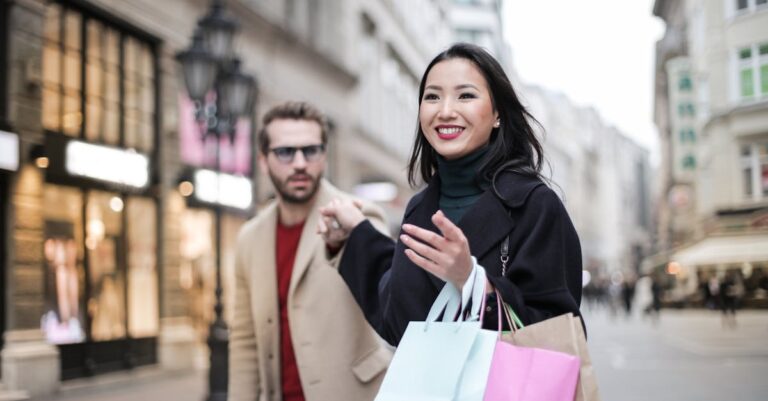 Woman in Black Coat Holding a Shopping Bags