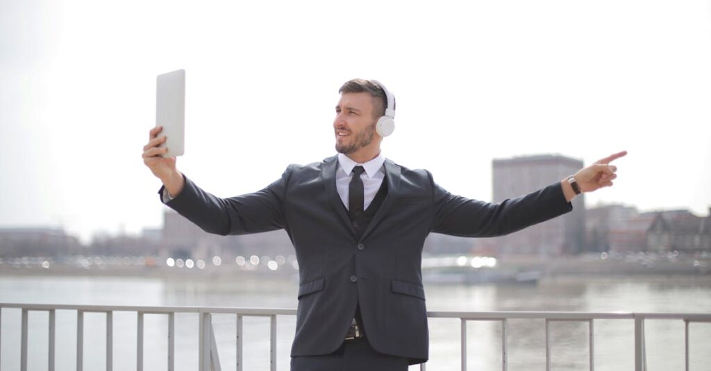 Man in Black Suit Jacket and Black Pants Standing Near the Railings