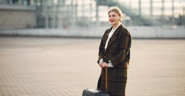 Happy young female passenger with luggage