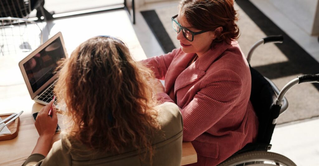 Woman in Red Sweater Wearing Black Framed Eyeglasses Sitting on Wheelchair