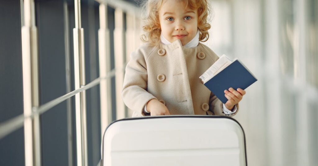 Cute little girl with suitcase and passport