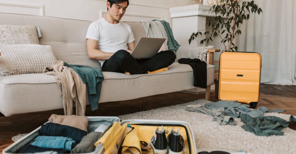 A Man Using His Laptop in a Messy Living Room