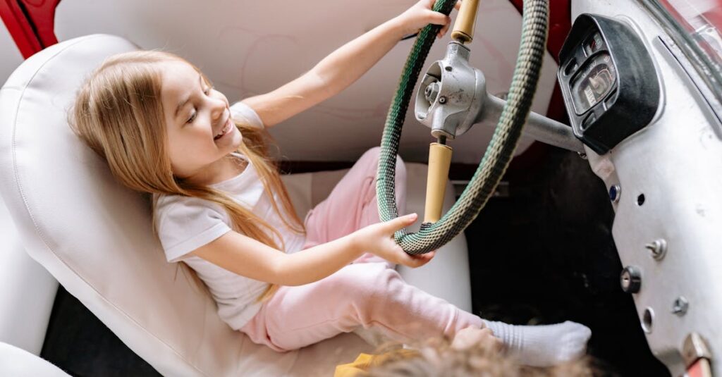 A Young Girl Sitting on the Car while Playing on Steering Wheel