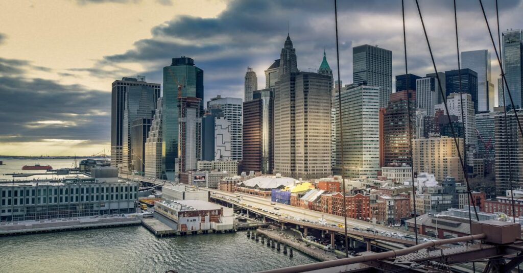 A stunning view of Manhattan skyline with iconic skyscrapers and waterfront at sunset.