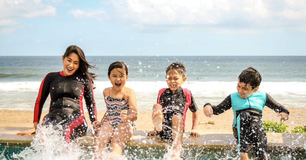 A family having fun splashing water near the seashore on a sunny day in Bali, Indonesia.